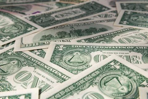 Macro Close-up of Scattered US Dollar Bills with Focus on One Dollar Pyramid Stock Photos
