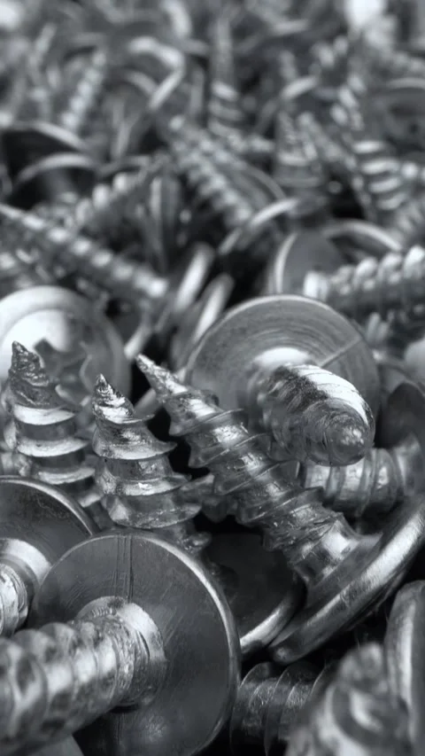 Macro close-up of shiny metal screws pile. Ideal for industrial Stock-Footage 342085299