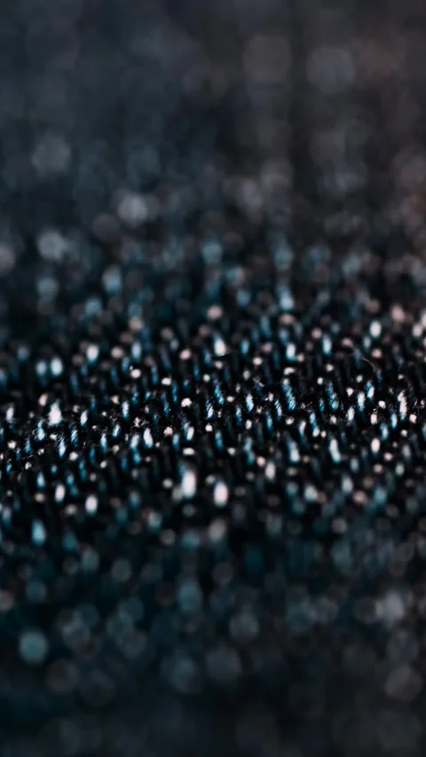 Macro close-up shot of denim fabric moving with a subtle bokeh effect captu.. Stock Footage 339344212