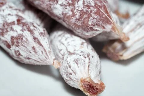 Macro close-up shot of dry cured sausages covered with white mold Stock Photos
