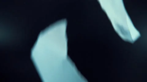 A macro close up shot of falling papers, white pages, professional studio Stock Footage 244856924