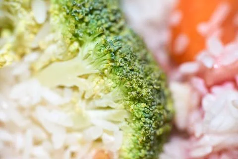Macro close-up shot of green broccoli florets served with cooked white rice Stock Photos