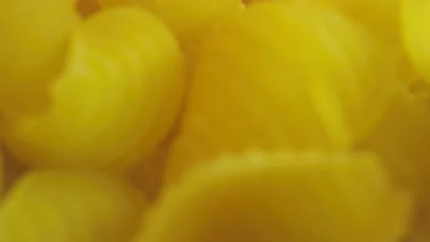 Macro close-up shot moving through pasta shells Stock Footage 131689425