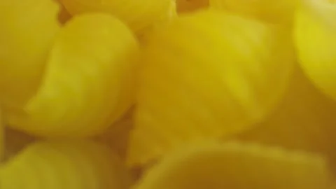 Macro close-up shot moving through pasta shells inside a bag Stock-Footage 131690739