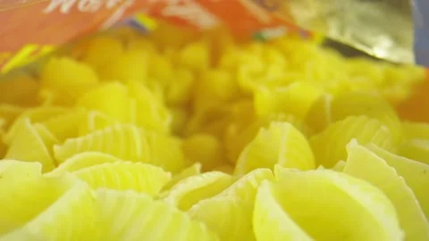 Macro close-up shot moving through pasta shells in a bag Stock Footage 131691088