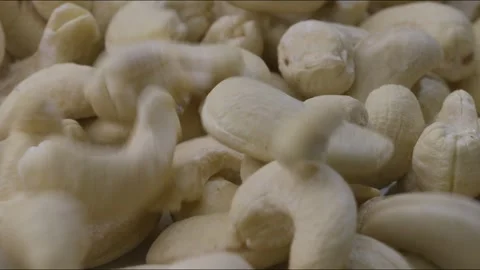 Macro close up shot of portion of cashew nuts and more being placed. Static Stock Footage 280260213