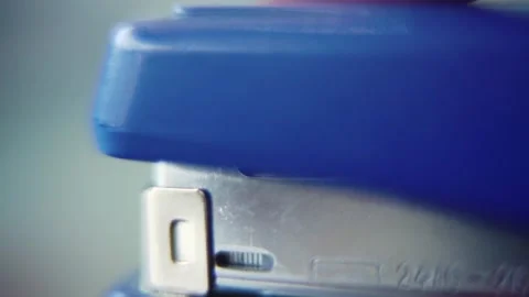 Macro close up shot, pressing on a blue stapler, slow motion 120 fps, Full Stock Footage 273689953