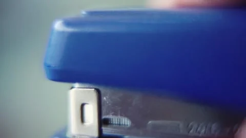 Macro close up shot, pressing on a blue stapler, slow motion 120 fps, Full Stock Footage 273690758