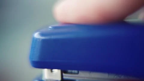 Macro close up shot, pressing on a blue stapler, super slow motion 120 Stock Footage 273690816