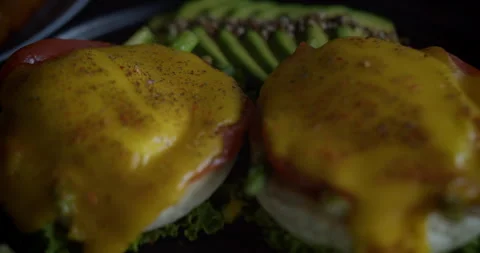 Macro close-up shot of sliced avocado, two poached eggs, cherry tomatoes, sliced Stock Footage 278430045