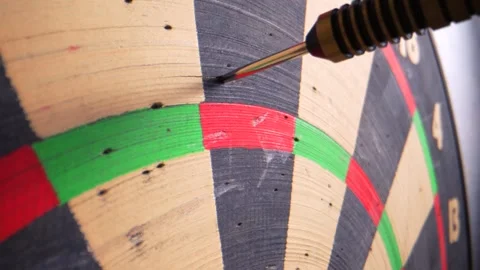 A macro close-up shows three darts thrown in slow motion, missing the triple 20 Stock Footage 295906383