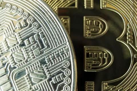 Macro close-up of silver and gold bitcoins. Stock Photos