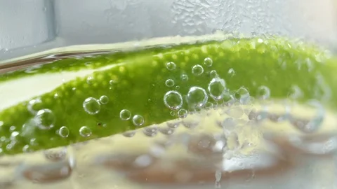 Macro close up slice lemon, ice cubes and bubble float soda water. Stock Footage 79022569