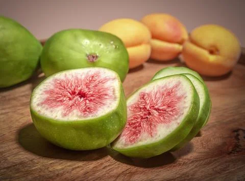 Macro close-up of sliced green figs showing ripe pink flesh Stock Photos