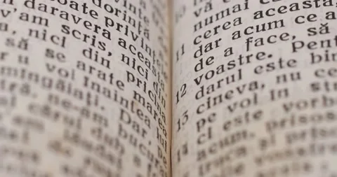 Macro close up slider shot of old book pages in foreign language. Gospel Bible Stock Footage 168749329