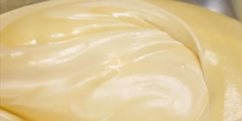 Macro Close-Up of Smooth Creamy Yellow Texture Swirls Видео 343589108