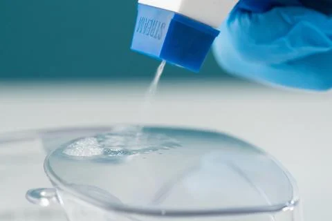 Macro close-up spray bottle spraying antiseptic on plastic contaminated product Stock Photos