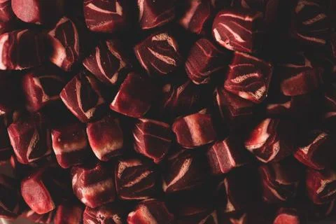 Macro close up of square shaped mini steak Dog treats snack, selective focus Stock Photos