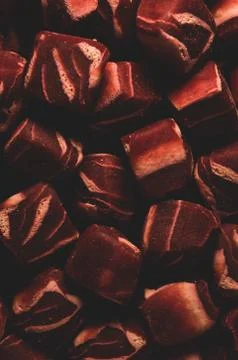 Macro close up of square shaped mini steak Dog treats snack, selective focus Stock Photos