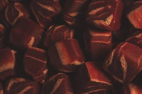 Macro close up of square shaped mini steak Dog treats snack, selective focus Stock Photos