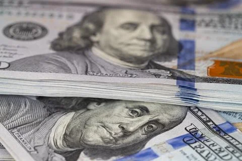 Macro close-up of a stack of one hundred US dollar bills with selective foc.. Stock Photos