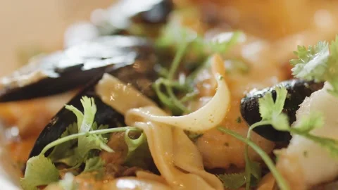 Macro Close-Up of Steaming Seafood Chowder with Herbs Stock Footage 314491257