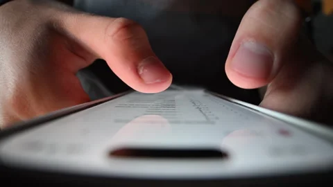 Macro close-up of student's finger tapping phone, studying online. Stock Footage 316233339