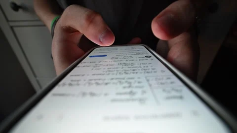 Macro close-up of student's finger tapping phone, studying online. Stock Footage 316233441
