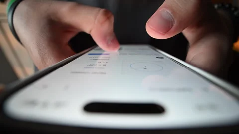 Macro close-up of student's finger tapping phone, studying online. 動画素材 316233485