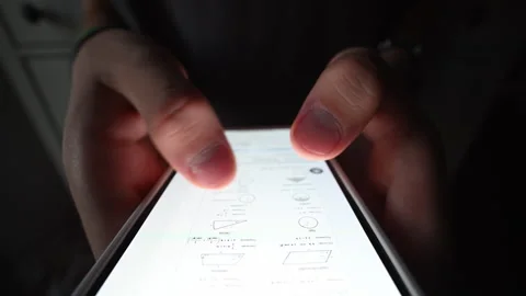 Macro close-up of student's finger tapping phone, studying online. 動画素材 316233488