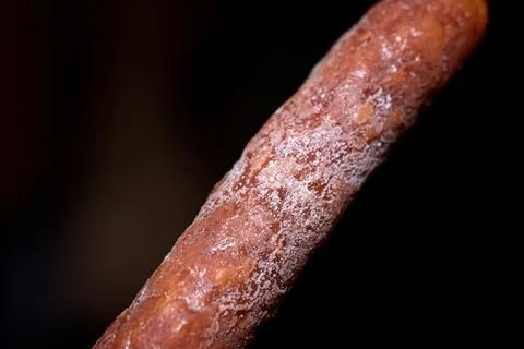 Macro close-up studio shot of a dry cured sausage with white mold coating Stock Photos