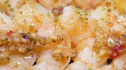 Macro Close-up of Succulent Garlic Butter Shrimp with Chili and Herbs Stock Footage 337440776