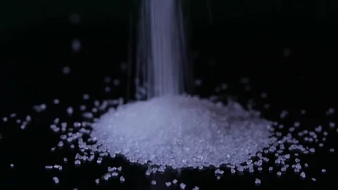 Macro close up of sugar falling to create and form a large pile Stock-Footage 70245028