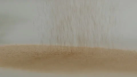 Macro close up tabletop chocolate powder fallin in slow motion Stock Footage 345149566