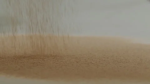 Macro close up tabletop chocolate powder fallin in slow motion Stock Footage 345149632