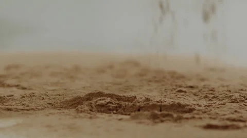 Macro close up tabletop chocolate powder fallin in slow motion Stock Footage 345149650