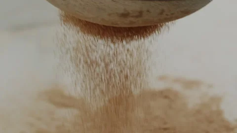 Macro close up tabletop chocolate powder fallin in slow motion Stock Footage 345149655