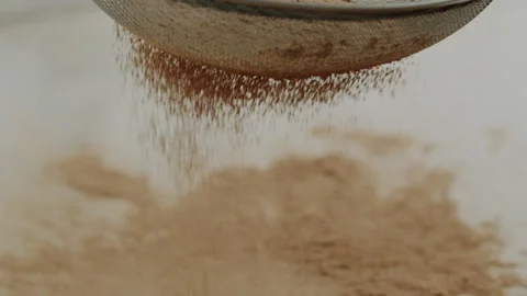 Macro close up tabletop chocolate powder fallin in slow motion Stock Footage 345149659