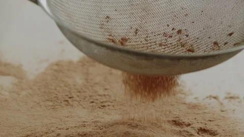 Macro close up tabletop chocolate powder fallin in slow motion Stock Footage 345149667