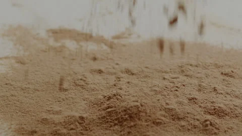 Macro close up tabletop chocolate powder fallin in slow motion Stock Footage 345149674