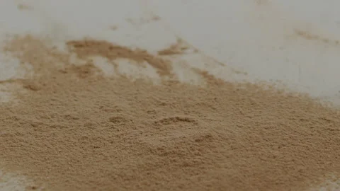 Macro close up tabletop chocolate powder fallin in slow motion Stock Footage 345149681