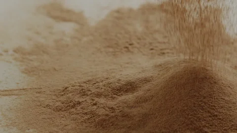 Macro close up tabletop chocolate powder fallin in slow motion Stock Footage 345149682