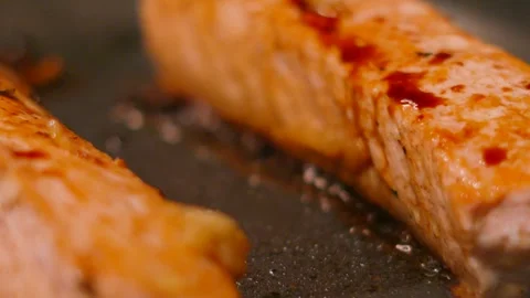 Macro Close-up with Texture of Two Sizzling Salmon Fillets Glazed in Soy Sauce Stock Footage 336028301