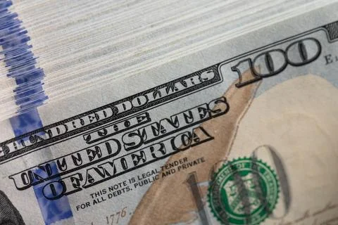 Macro close up of thick 100 US dollar bill stack with blue 3D security ribb.. Stock Photos