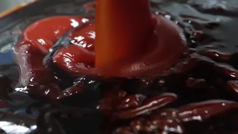 Macro Close-Up of Thick Red Tomato Paste Swirling and Pouring Stock Footage 331956073