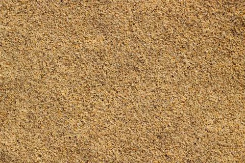 Macro close up tiny grains of sand on a beach. Fotos Stock