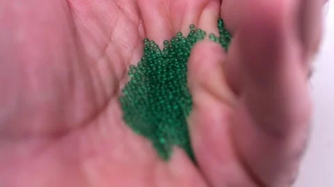 Macro close-up of tiny green balls, suggestive of an innovative medication .. Video stock 275040769