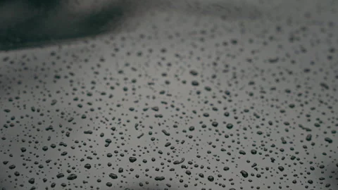 Macro Close Up of Tiny Raindrops on Black Metallic Surface of a Car Stock Footage 345549113