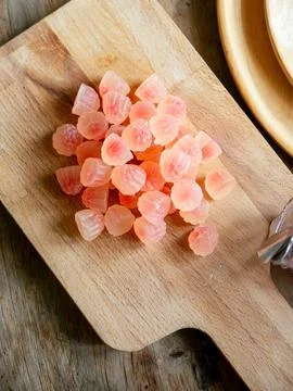 Macro close-up of translucent pink red flower-shaped health gummy vitamin s.. Foto stock