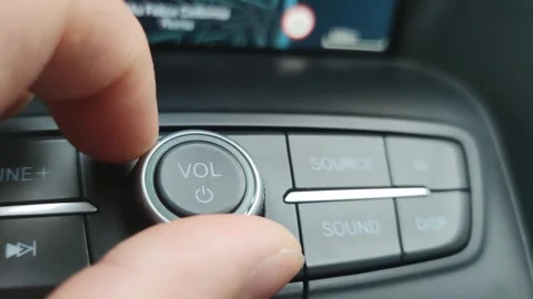 Macro close-up, turning down the volume of the car radio Stock Footage 254806344